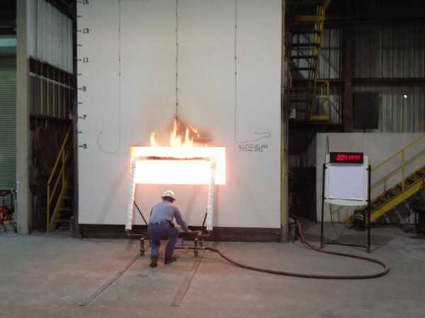NFPA 285 testing, per the International Building Code, subjects envelope components such as foam plastic insulation, combustible exterior claddings, water-resistive barriers, and tapes to demonstrate limited fire propagation.